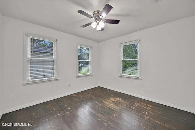 wooden floor in an empty room with a window