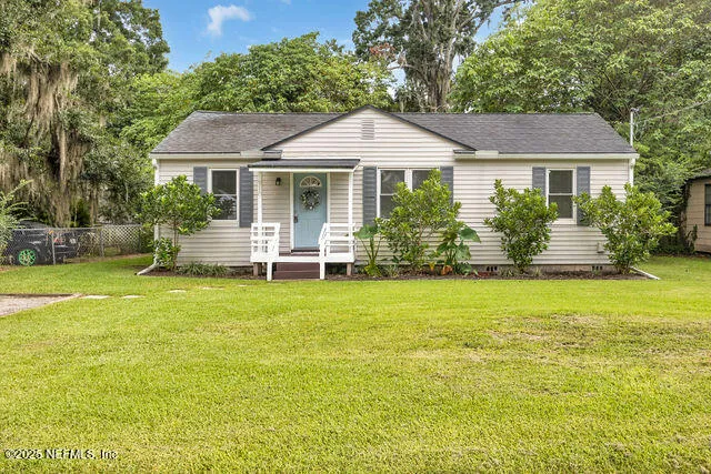 a front view of a house with a garden