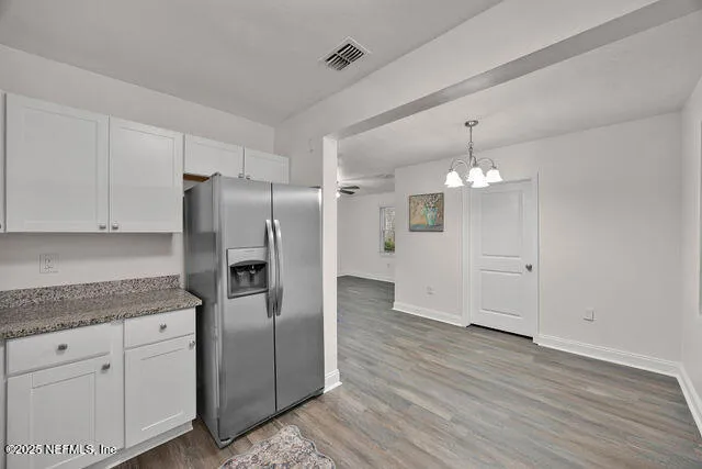 a view of a kitchen with a stove cabinets