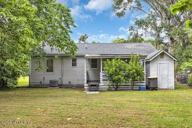 a view of house with garden space and trees