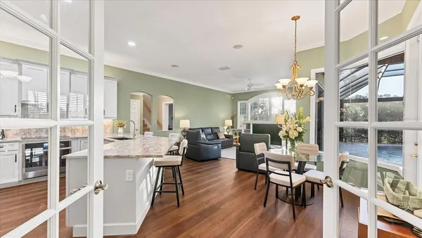 a living room with furniture dining table and a large window