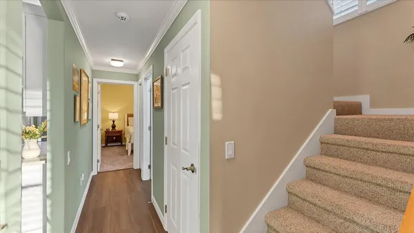 a view of a hallway with wooden floor and entryway