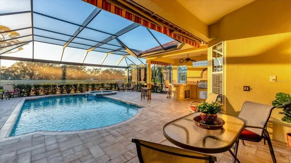 a view of a swimming pool with outdoor seating