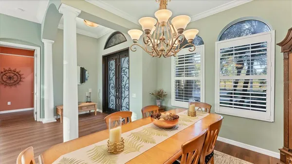 a view of a dining room with furniture wooden floor and chandelier