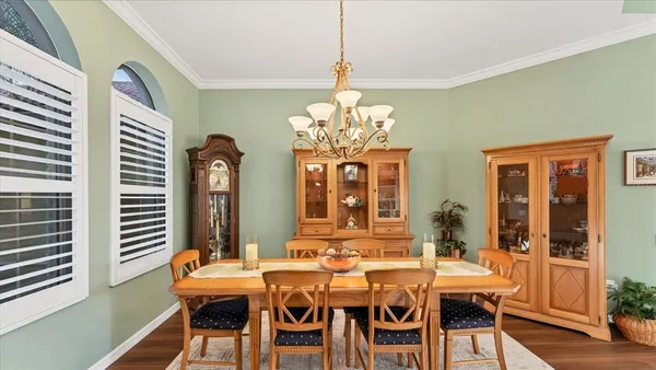 a view of a dining room with furniture and chandelier