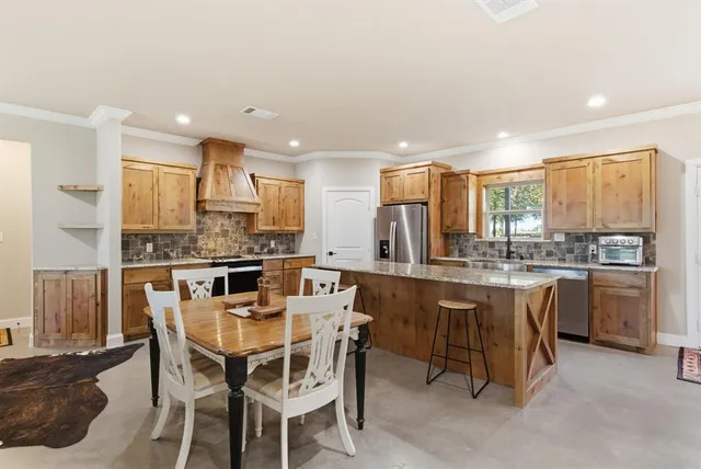 a kitchen with kitchen island granite countertop wooden cabinets and counter space