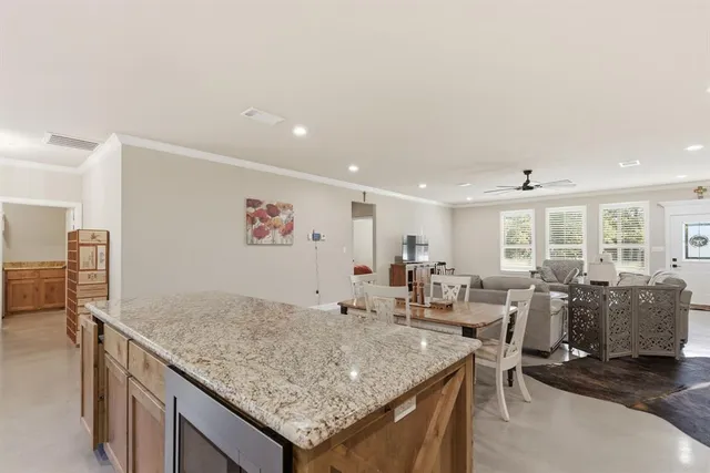 a living room with granite countertop furniture and a kitchen view