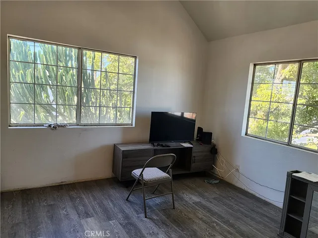 a view of a workspace with furniture and a window