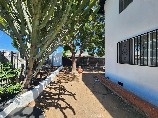 a backyard of a house with table and chairs