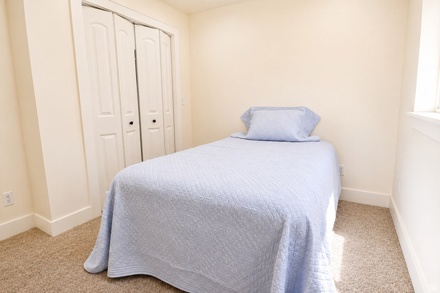 1055 North 1000 East Mapleton, UT 84664 - Photo 68 of 112 Bedroom featuring neutral carpeting, a window with white trim, and bi-fold closet doors with black hardware