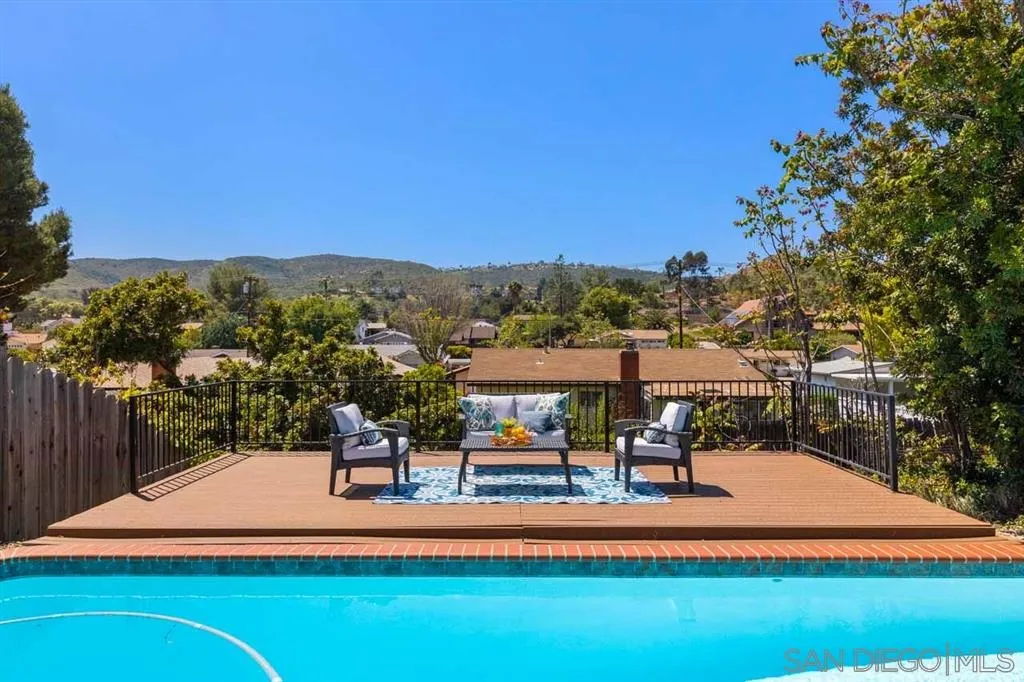13916 Frame Road Poway, CA 92064 - Photo 1 of 19 a view of a swimming pool with a table and chairs