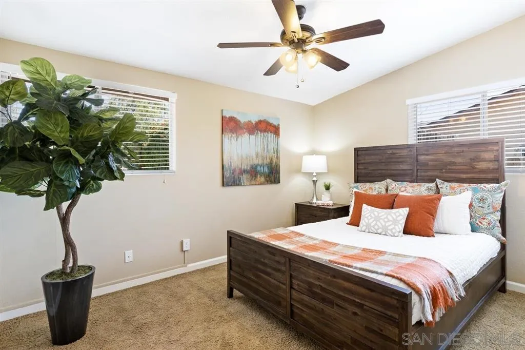 13916 Frame Road Poway, CA 92064 - Photo 12 of 19 a bedroom with a balcony a bed and a potted plant