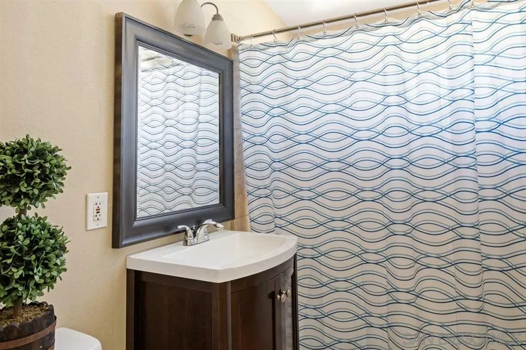 13916 Frame Road Poway, CA 92064 - Photo 16 of 19 a bathroom with a sink and a mirror