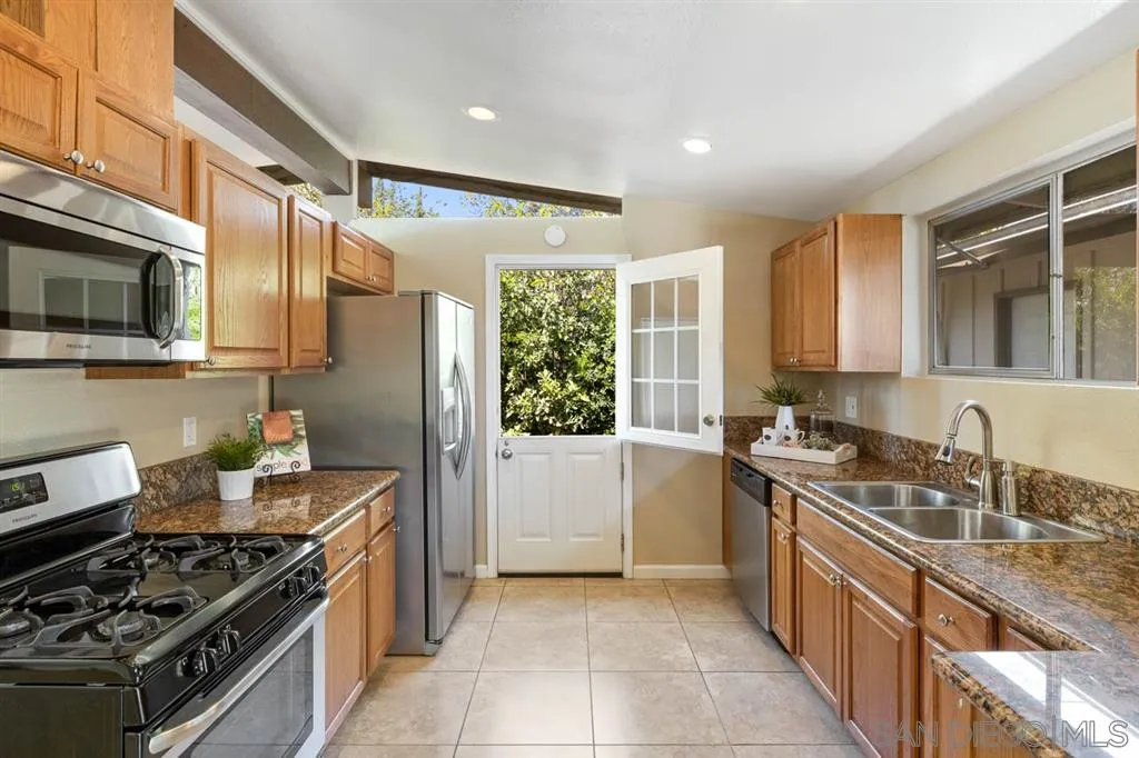 13916 Frame Road Poway, CA 92064 - Photo 6 of 19 a kitchen with stainless steel appliances granite countertop a stove a sink and a refrigerator