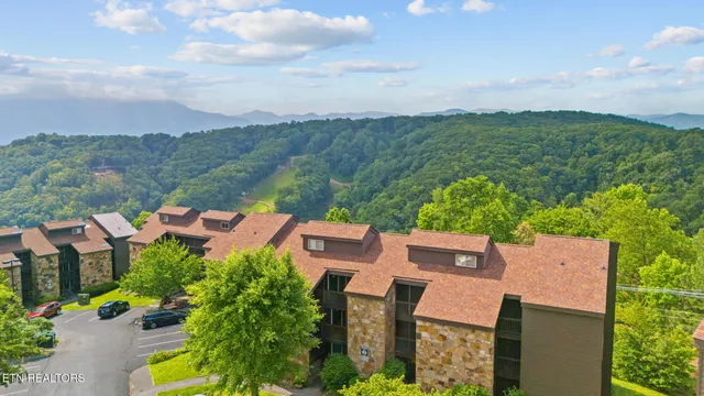 an aerial view of a house with garden space and outdoor seating
