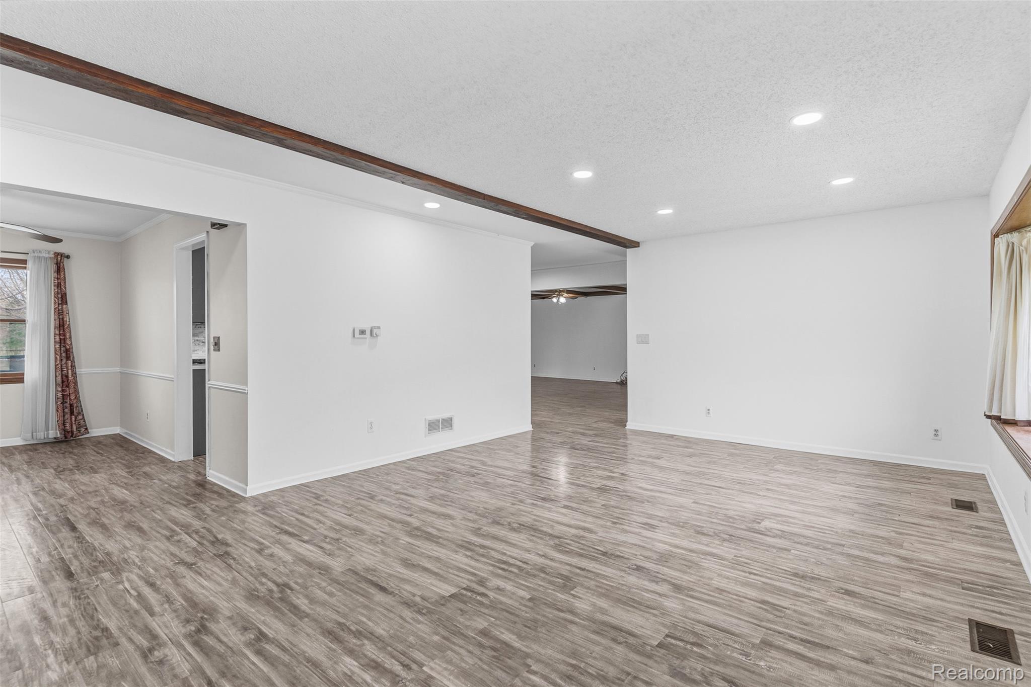 3432 South State Road Davison, MI 48423 - Photo 8 of 58 Unfurnished living room with a ceiling fan, a textured ceiling, recessed lighting, and light wood-style flooring