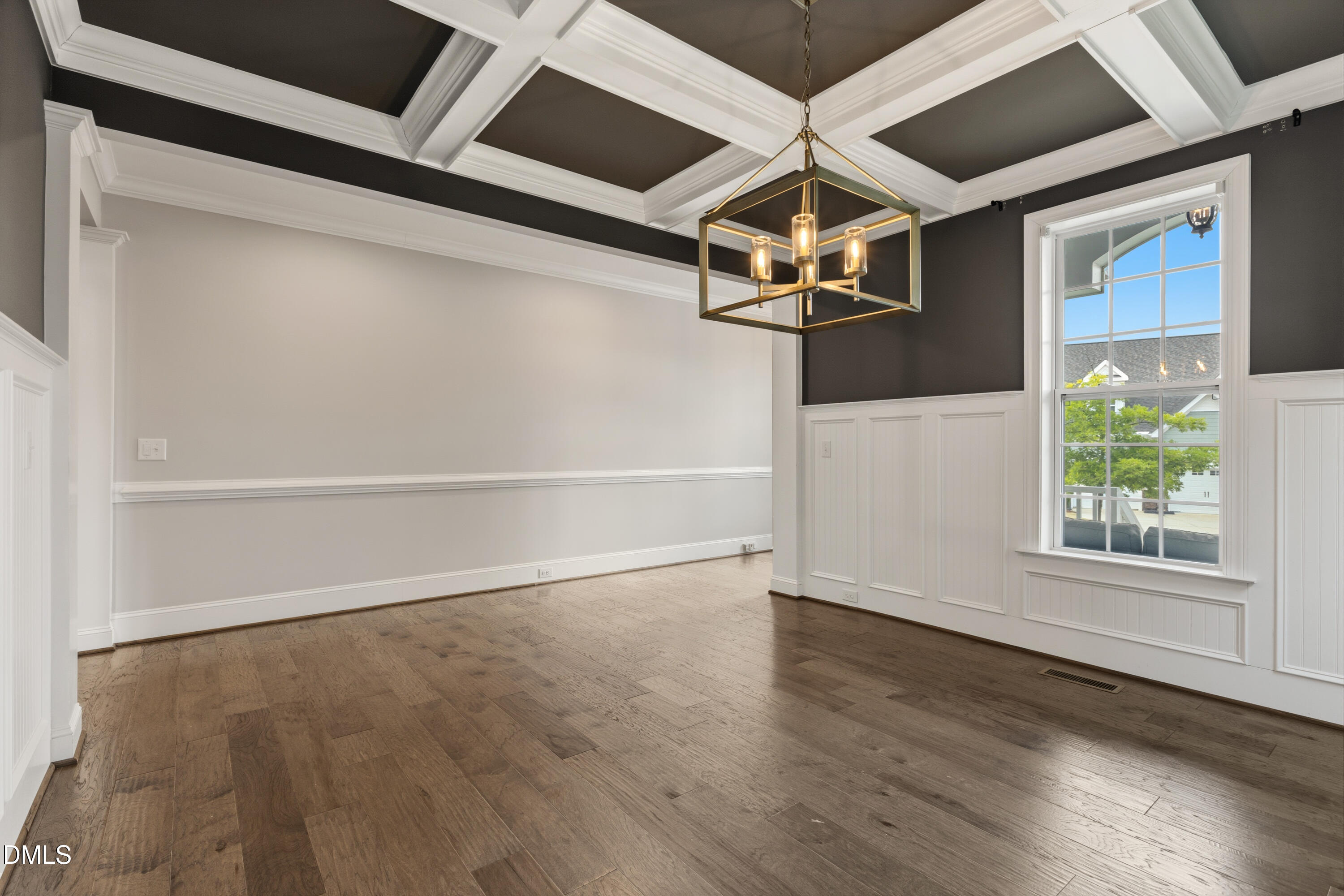 7421 Stonehenge Farm Lane Raleigh, NC 27613 - Photo 17 of 48 a view of an empty room with wooden floor and a window