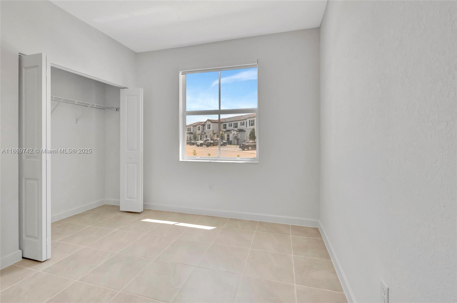 12206 Northwest 23rd Avenue Miami, FL 33167 - Photo 12 of 25 an empty room with windows