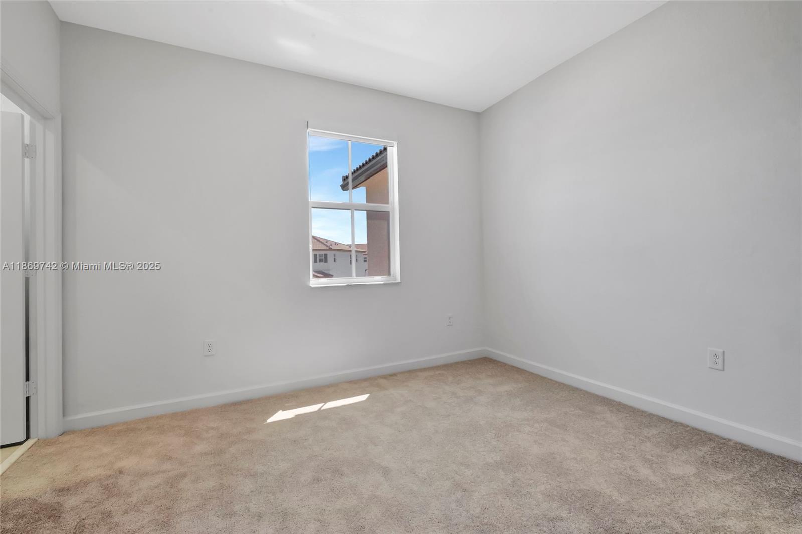 12206 Northwest 23rd Avenue Miami, FL 33167 - Photo 14 of 25 an empty room with a window