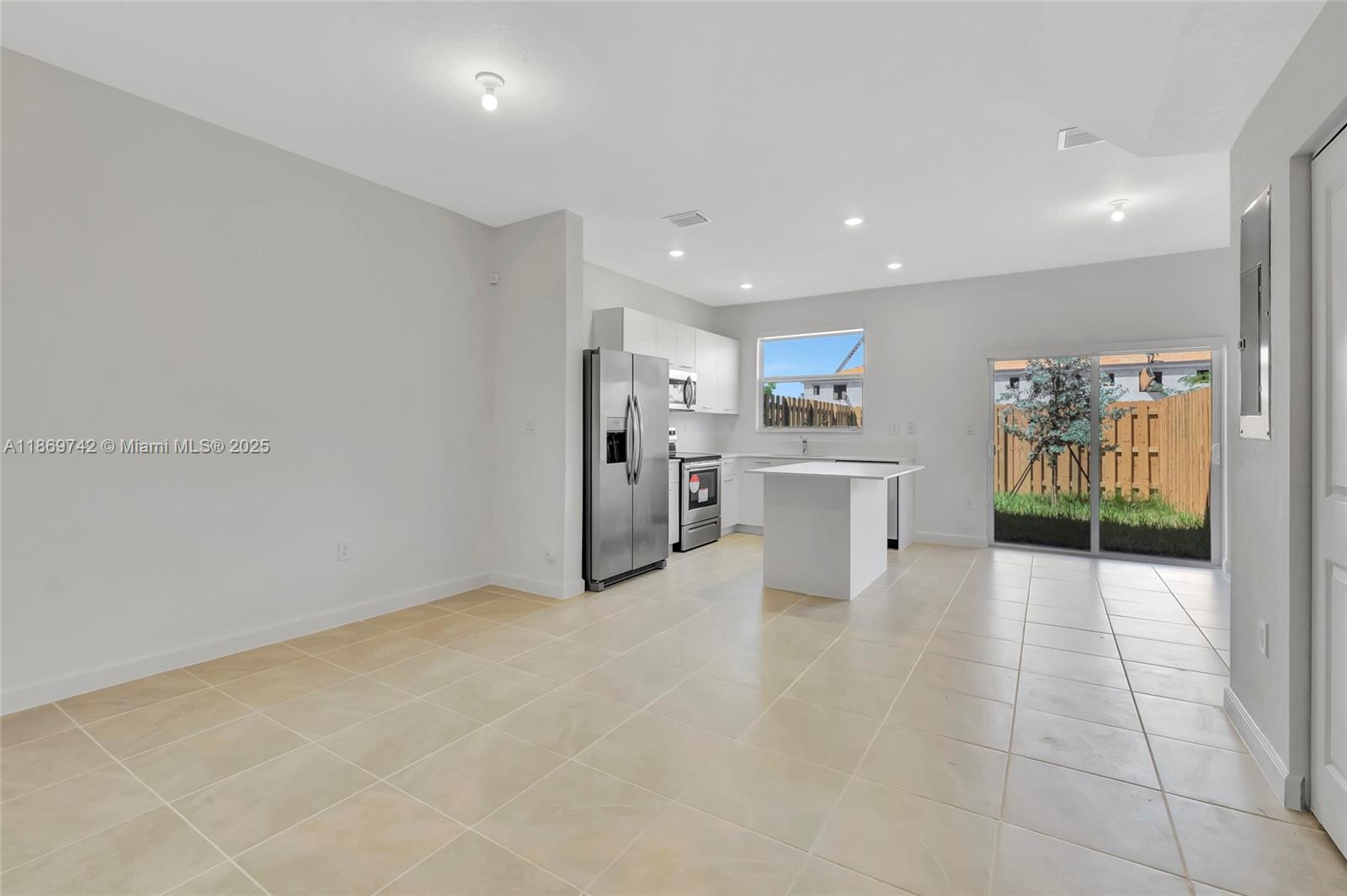 12206 Northwest 23rd Avenue Miami, FL 33167 - Photo 2 of 25 a view of a kitchen with refrigerator and furniture