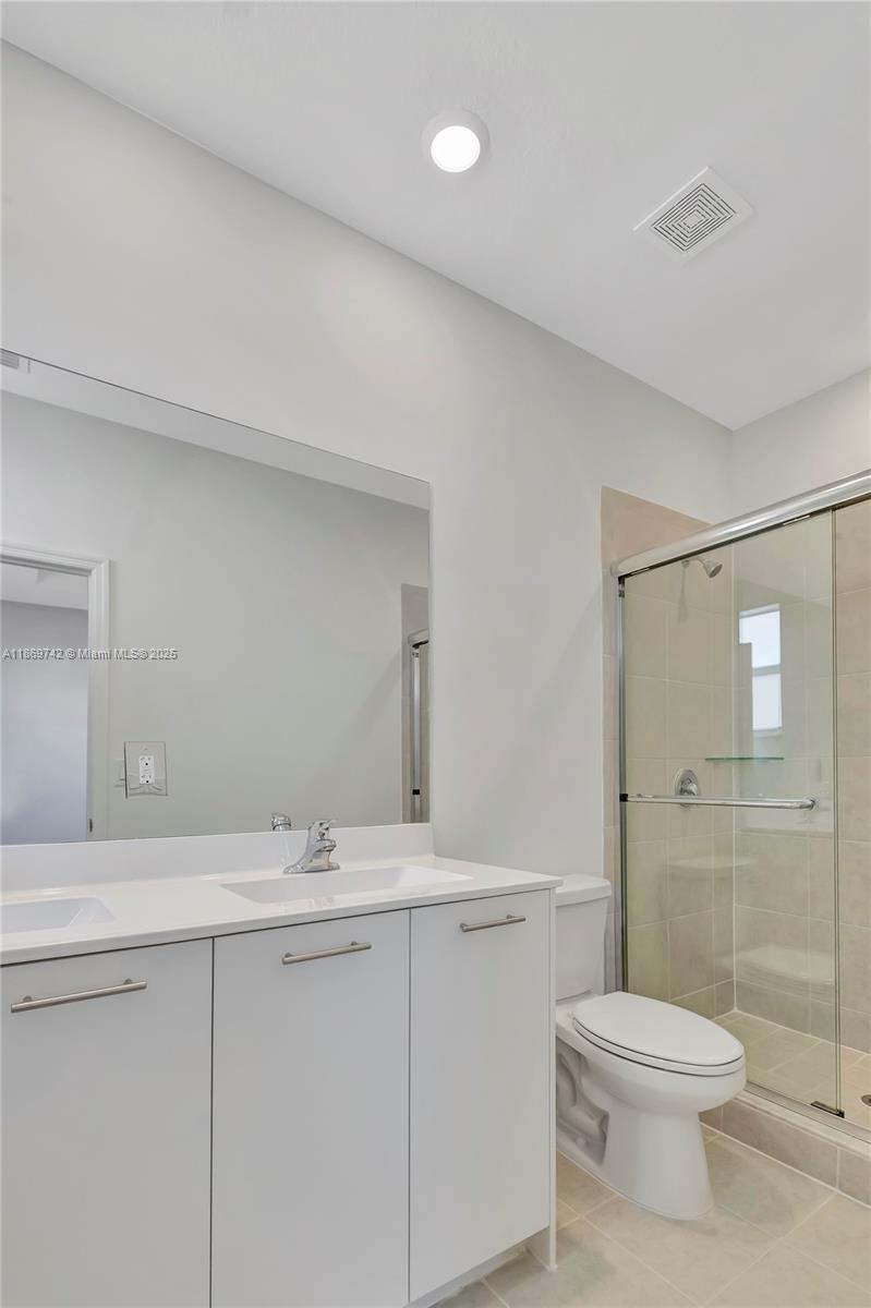 12206 Northwest 23rd Avenue Miami, FL 33167 - Photo 21 of 25 a bathroom with a sink a toilet and shower