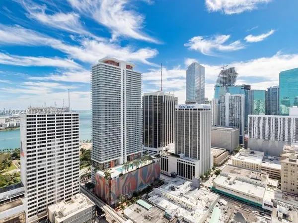 a living room with fireplace furniture and a large window