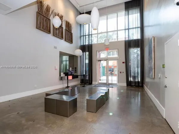 a lobby with furniture and a chandelier