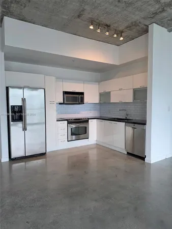 a view of a kitchen with a sink and a fireplace