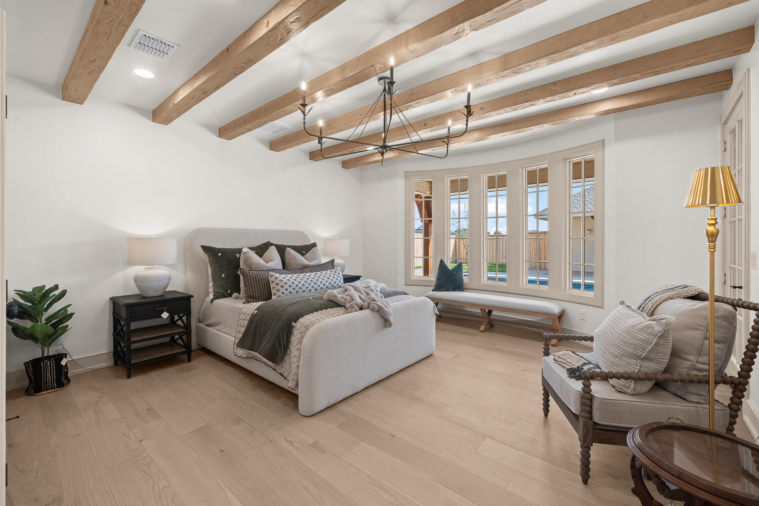 3911 149th Street Lubbock, TX 79423 - Photo 36 of 79 a spacious bedroom with a bed and a chandelier