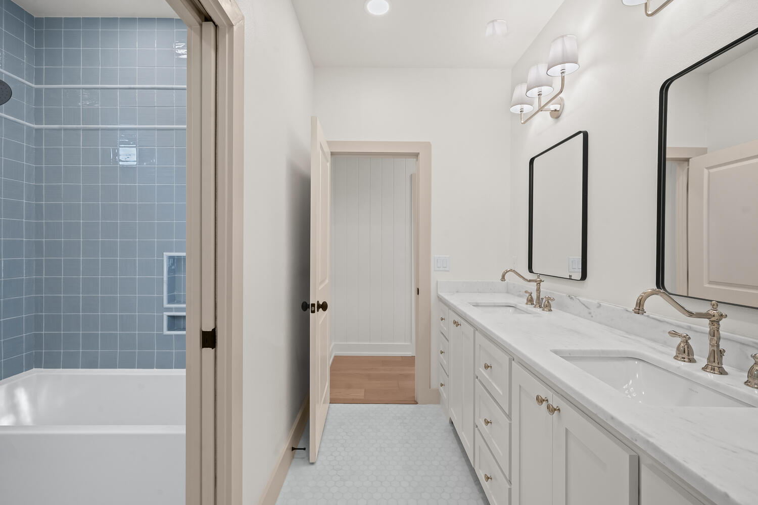 3911 149th Street Lubbock, TX 79423 - Photo 66 of 79 a bathroom with a double vanity sink a mirror and a bathtub