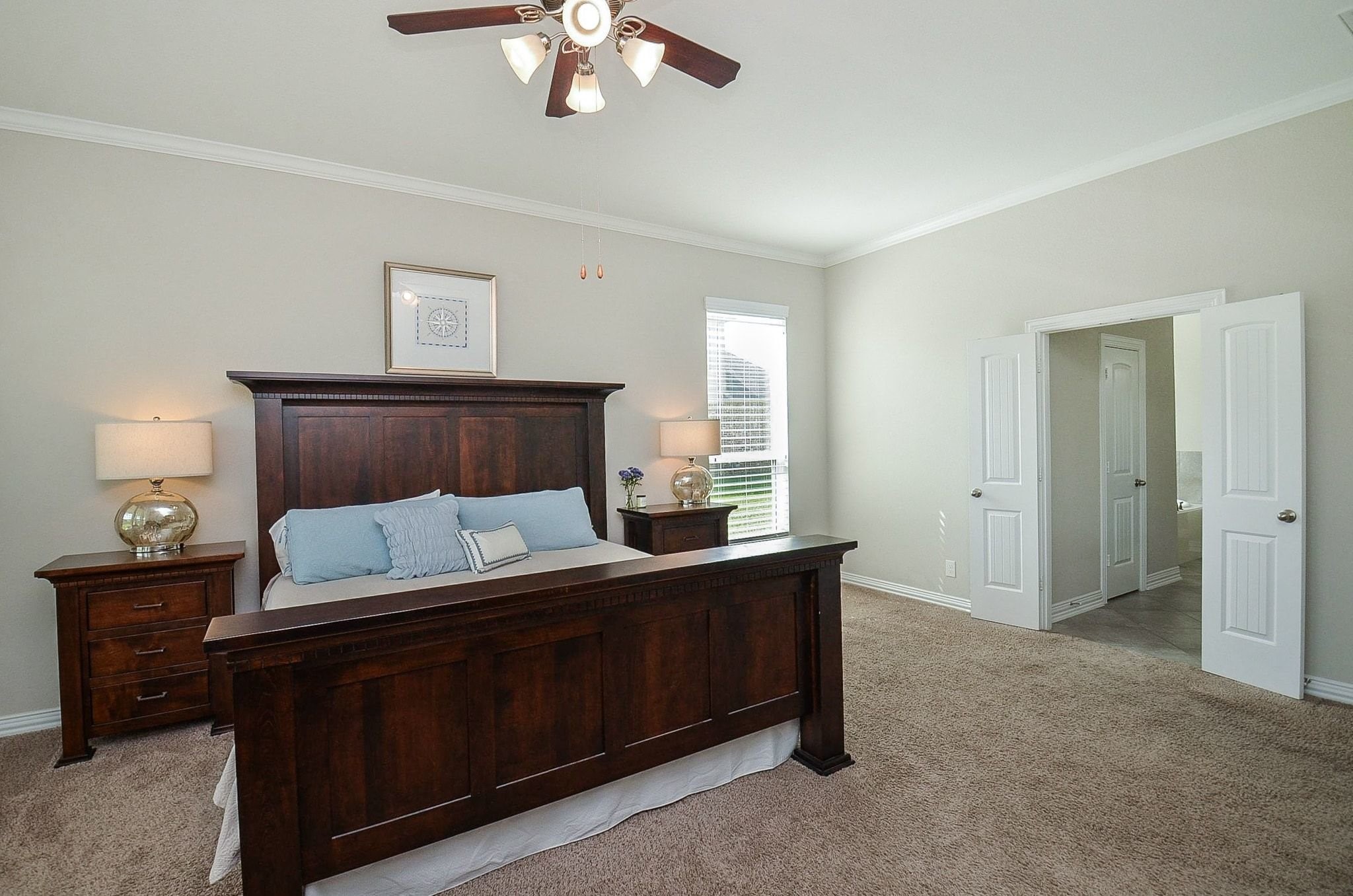2714 Topaz Cove Lane Rosharon, TX 77583 - Photo 26 of 50 a bedroom with a bed and a lamp on dresser