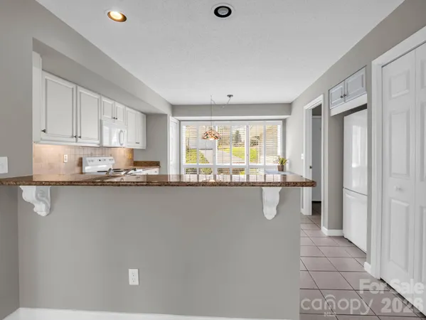 a kitchen that has a cabinets and a stove
