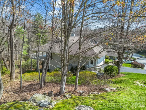 a house that has a tree in front of it