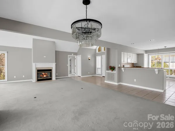 a kitchen with white cabinets and window