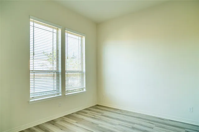 a view of a kitchen with kitchen island a large counter top space and stainless steel appliances