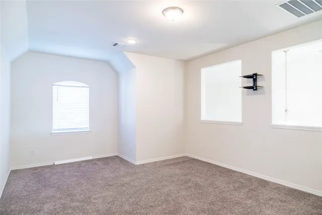 an empty room with windows and closet