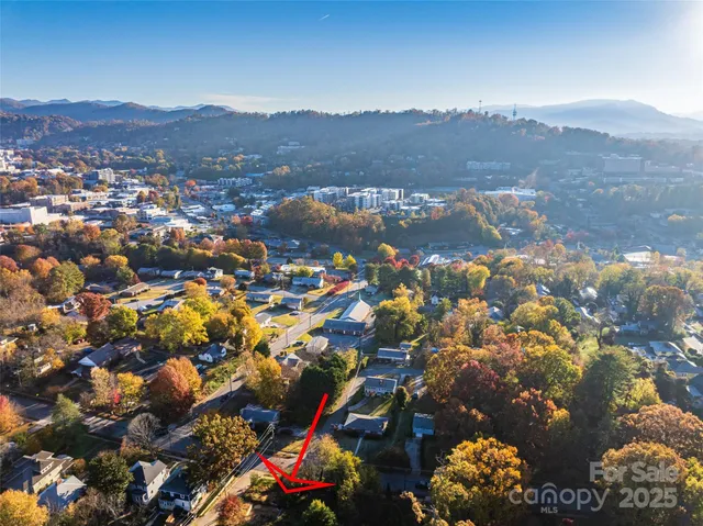 an aerial view of residential houses and outdoor space