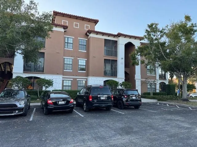 a city street lined with parked cars and buildings