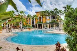 a view of a house next to a yard with a fountain