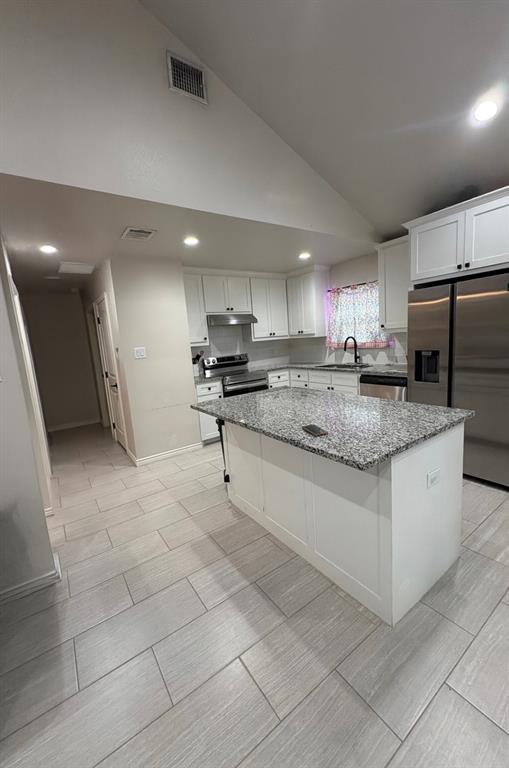 1610 Ridgeview Circle Granbury, TX 76048 - Photo 4 of 13 a kitchen with stainless steel appliances granite countertop a stove a sink a microwave and a refrigerator