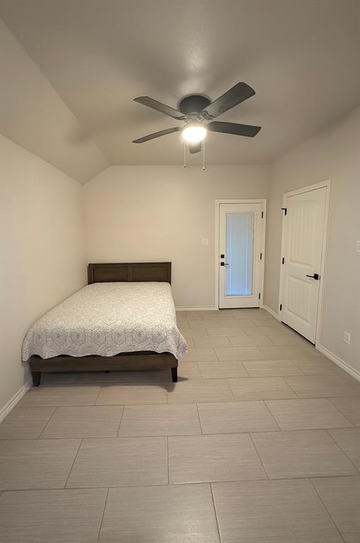 1610 Ridgeview Circle Granbury, TX 76048 - Photo 7 of 13 a spacious bedroom with a bed and ceiling fan