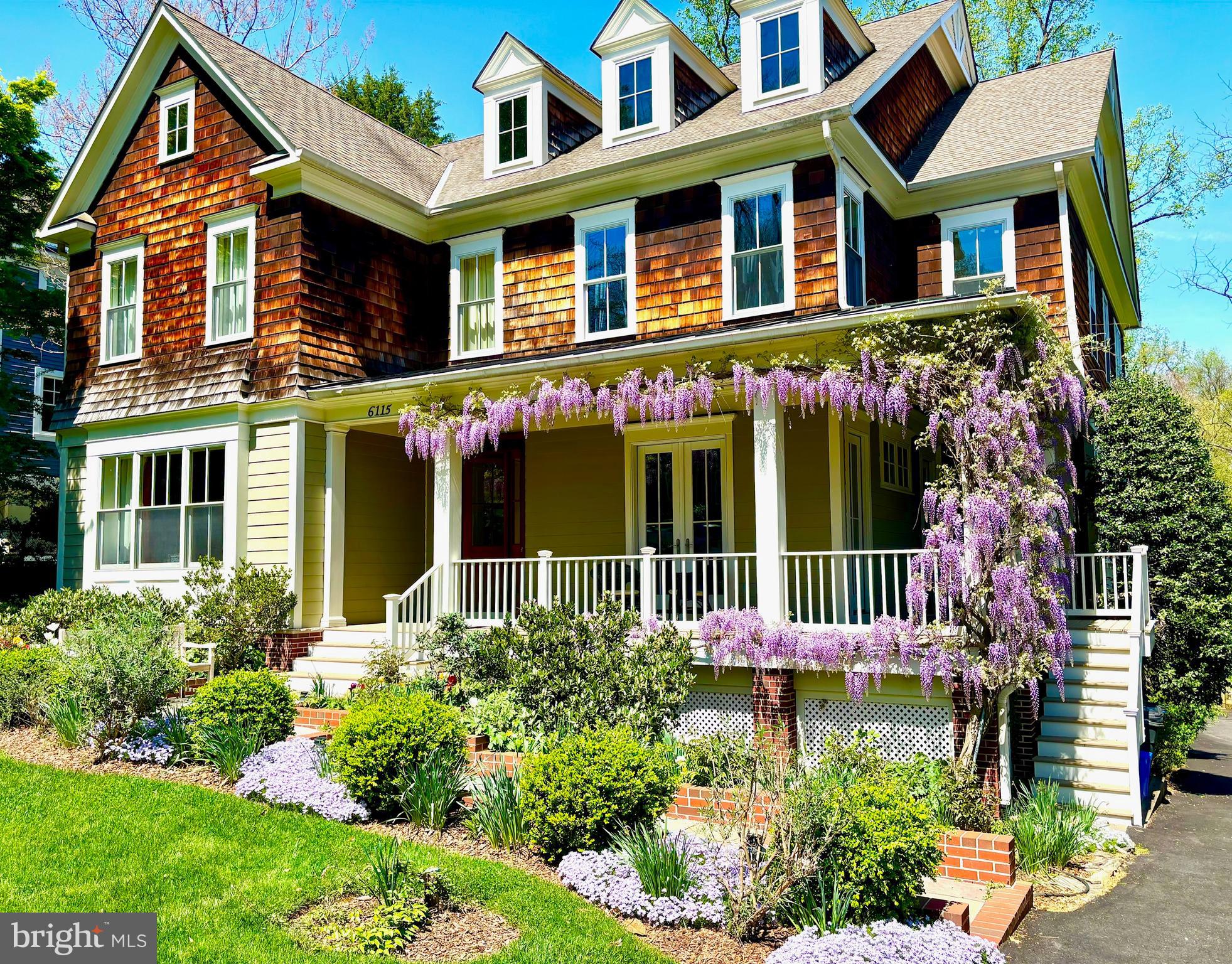 6115 Madawaska Road Bethesda, MD 20816 - Photo 1 of 1 front view of a brick house with a yard and plants