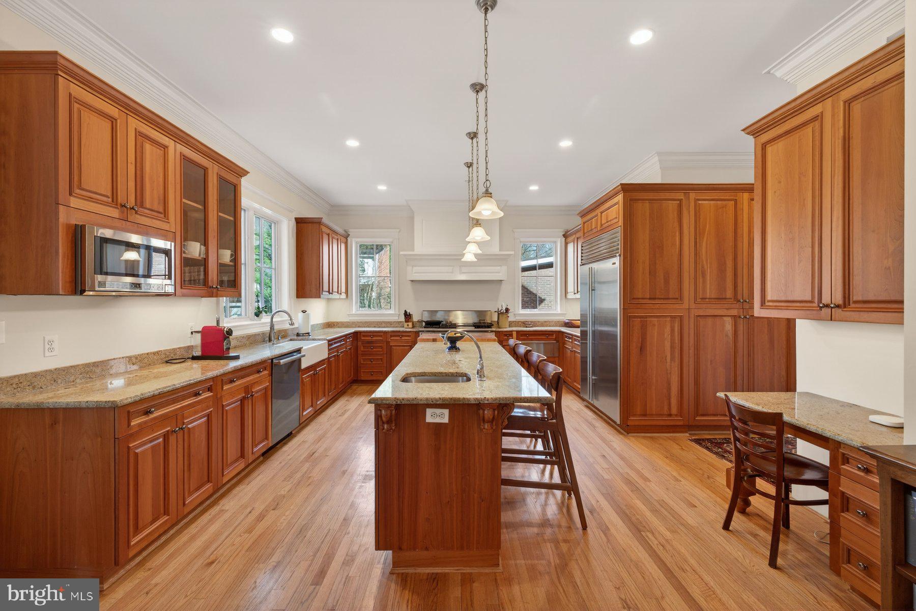 6115 Madawaska Road Bethesda, MD 20816 - Photo 19 of 78 a kitchen with stainless steel appliances granite countertop a stove a refrigerator a sink dishwasher and wooden cabinets with wooden floor