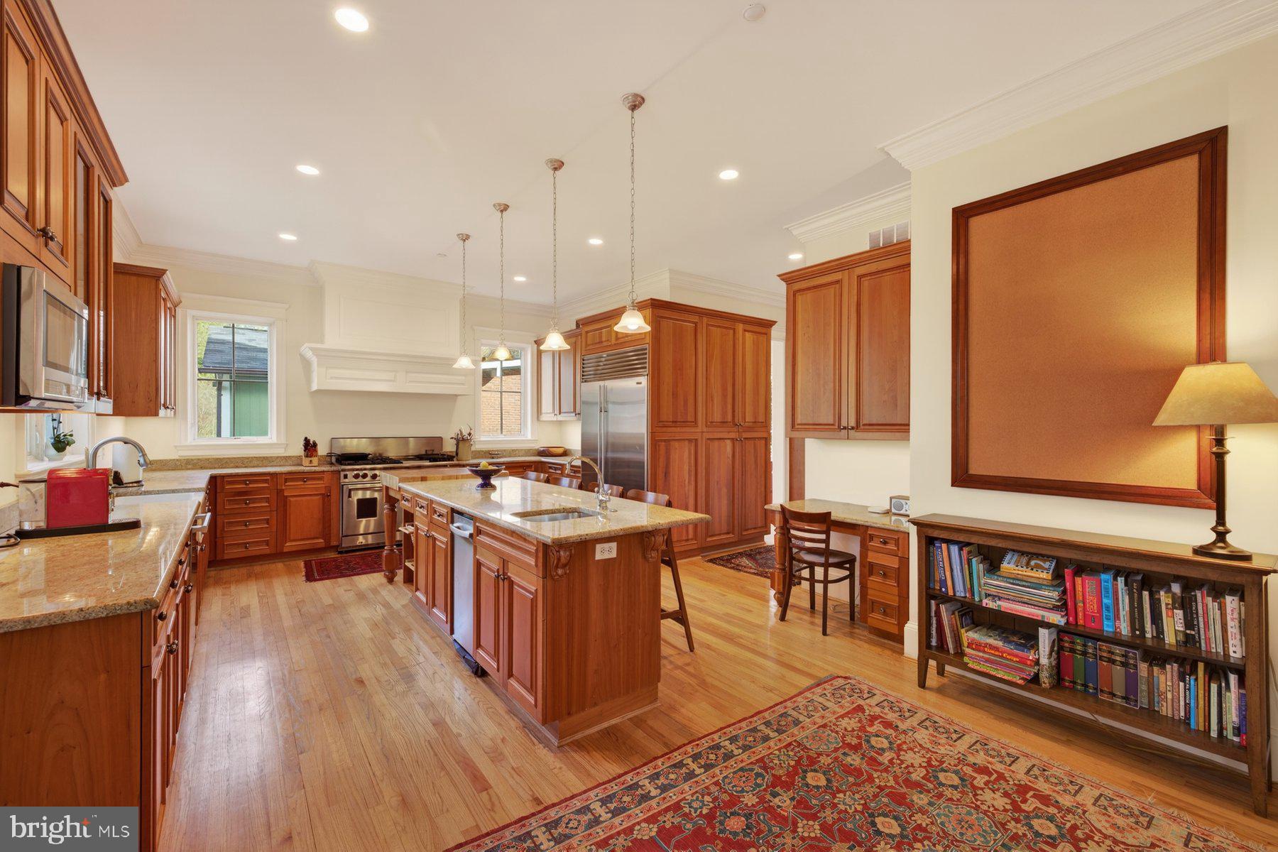 6115 Madawaska Road Bethesda, MD 20816 - Photo 20 of 78 a kitchen with stainless steel appliances granite countertop a stove top oven a sink dishwasher and a dining table with wooden floor