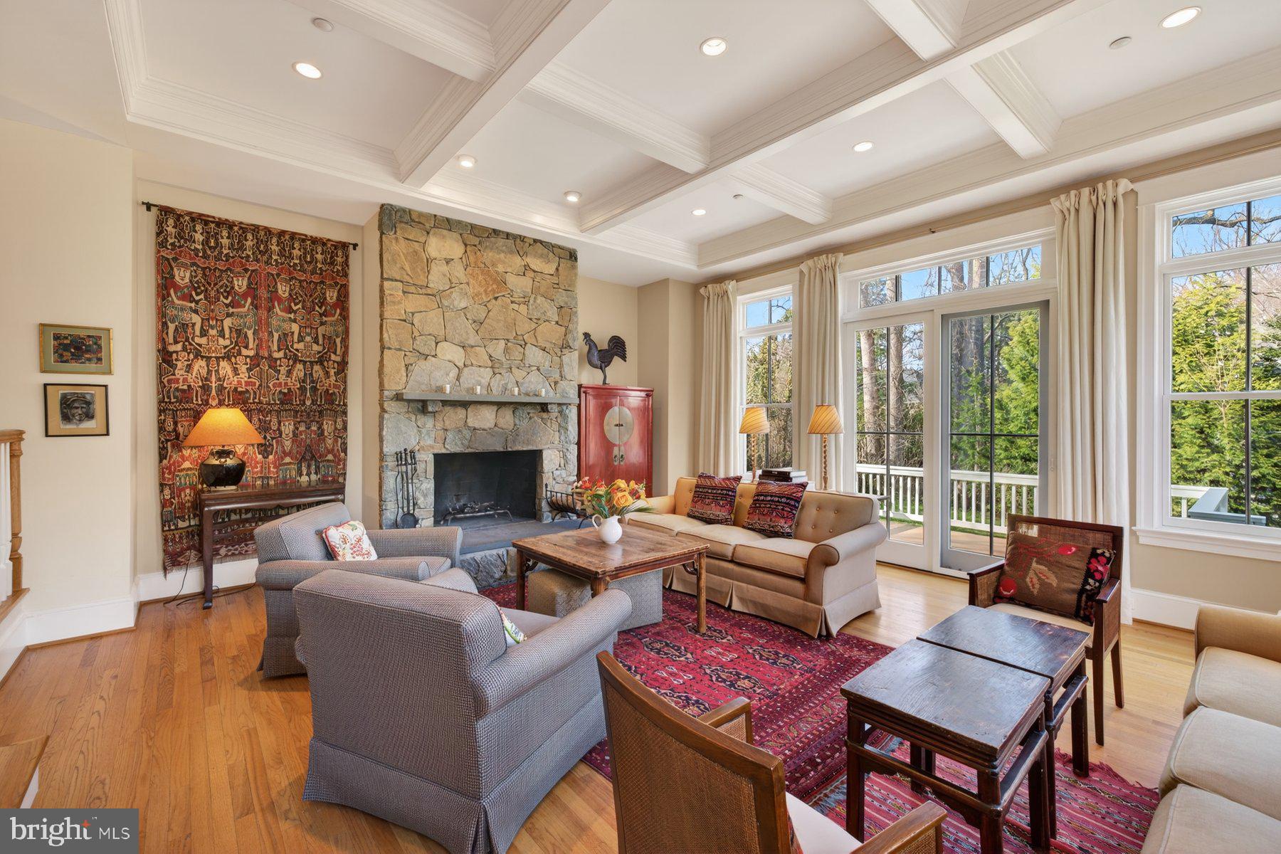 6115 Madawaska Road Bethesda, MD 20816 - Photo 26 of 78 a living room with furniture a fireplace and a floor to ceiling window