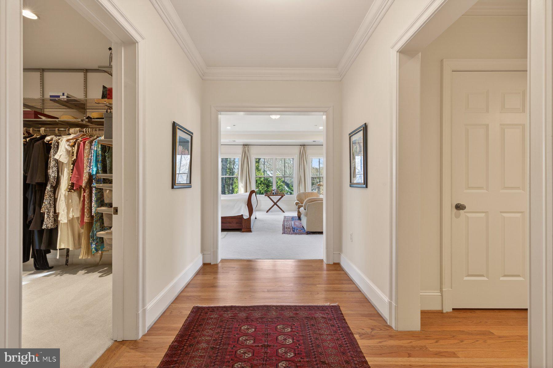 6115 Madawaska Road Bethesda, MD 20816 - Photo 29 of 78 a view of a hallway with wooden floor and a living room