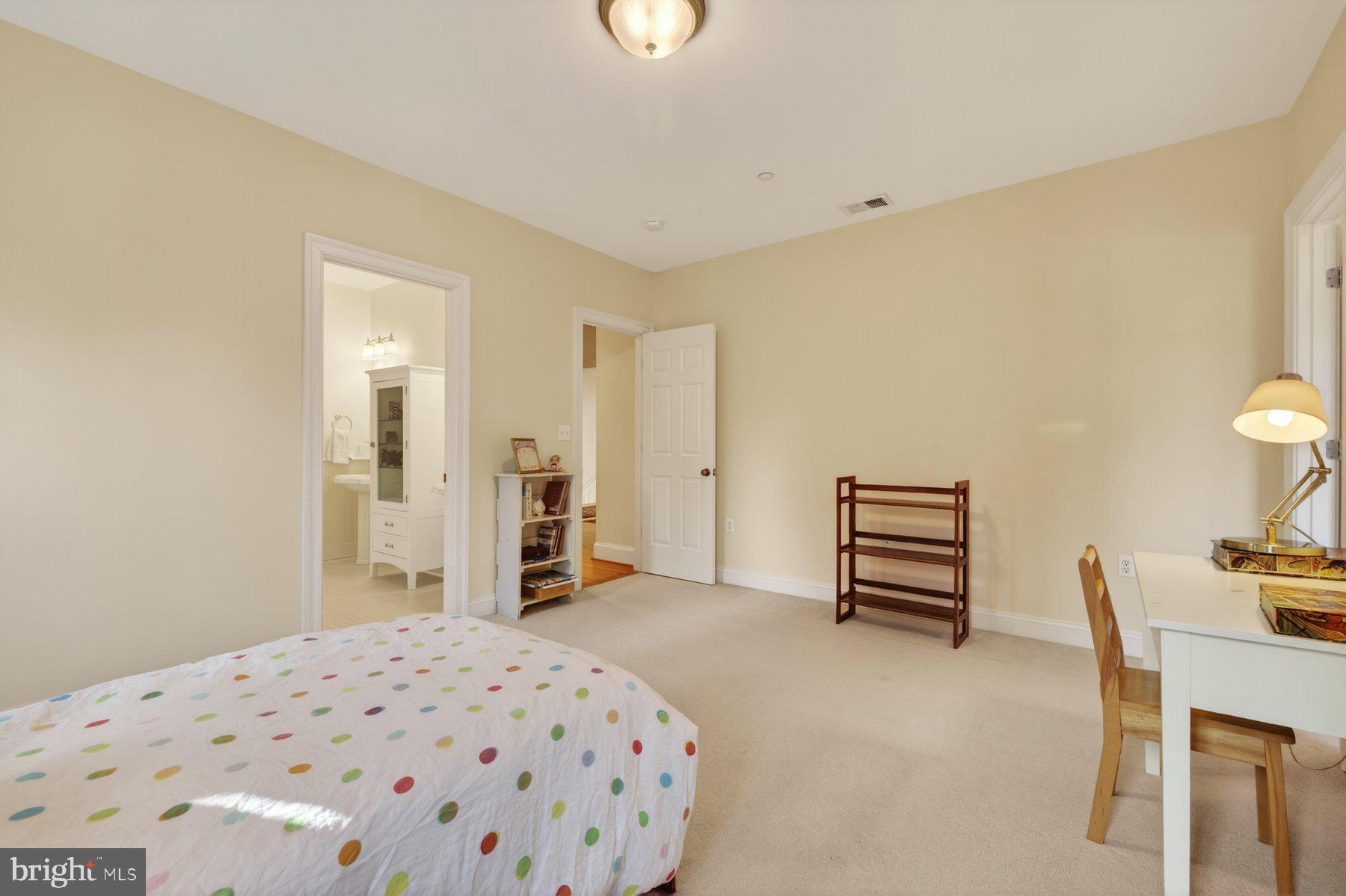 6115 Madawaska Road Bethesda, MD 20816 - Photo 41 of 78 a bedroom with a bed and a desk in it