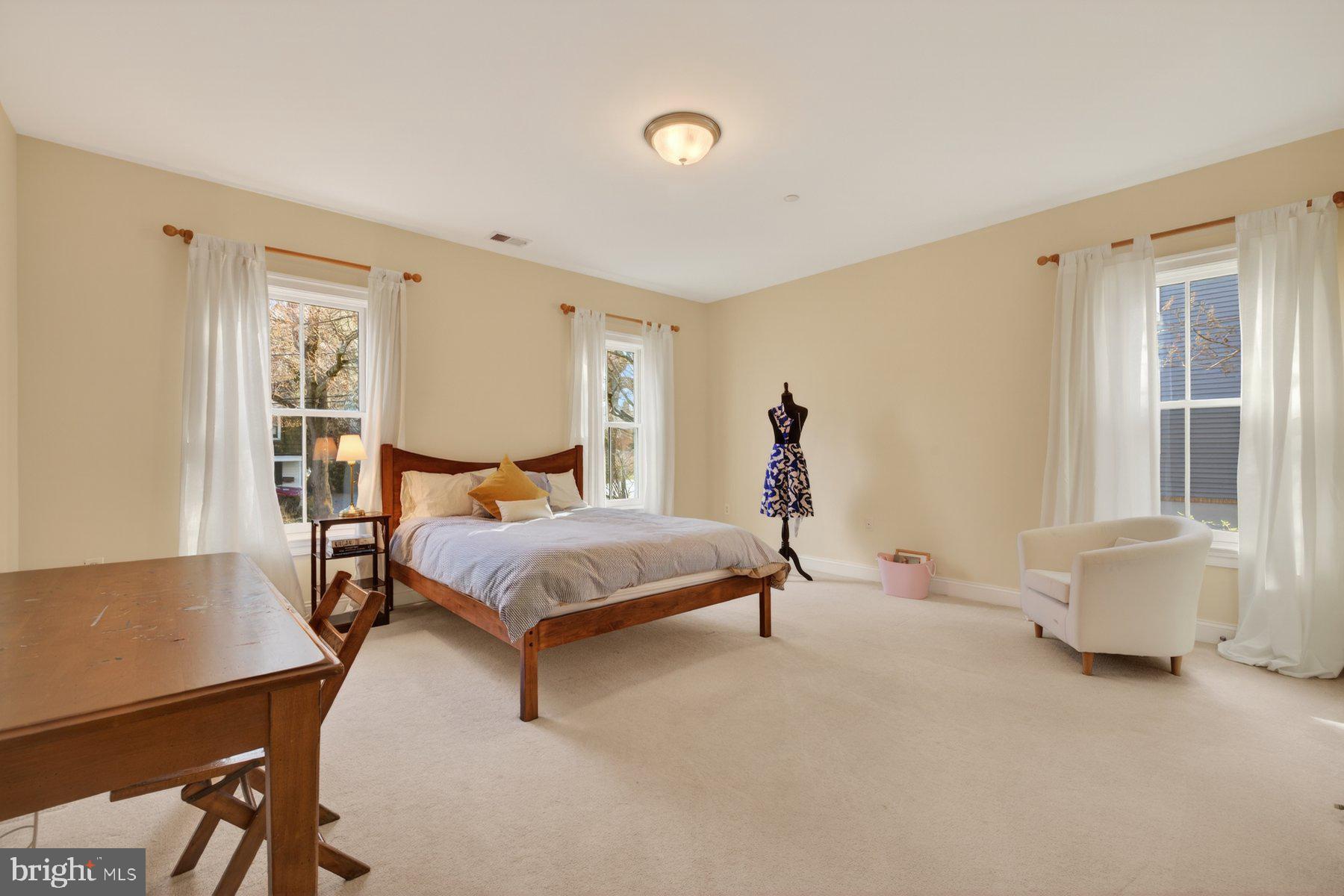 6115 Madawaska Road Bethesda, MD 20816 - Photo 44 of 78 a bedroom with a bed and wooden floor