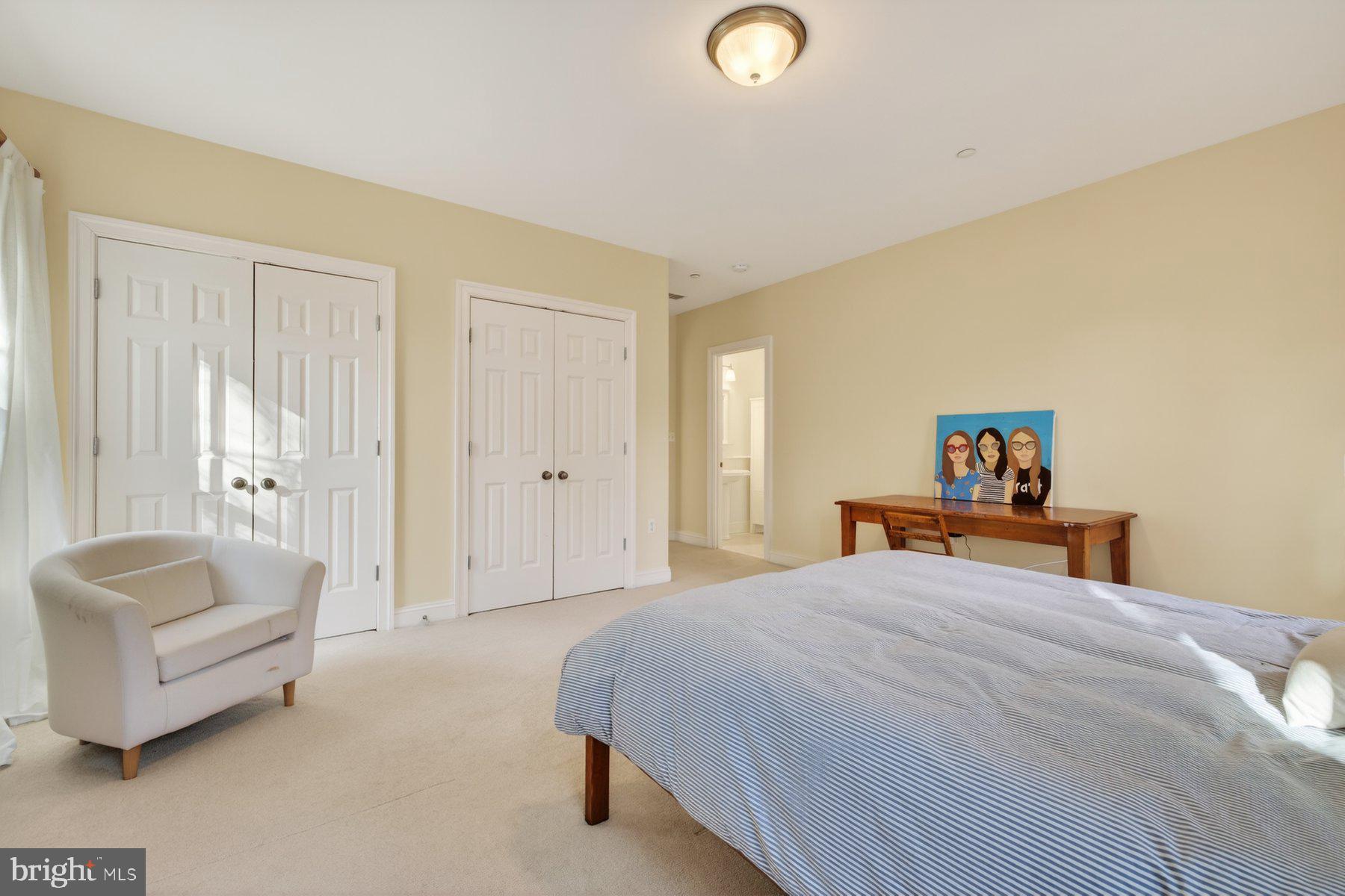 6115 Madawaska Road Bethesda, MD 20816 - Photo 45 of 78 a bedroom with a bed and a couch