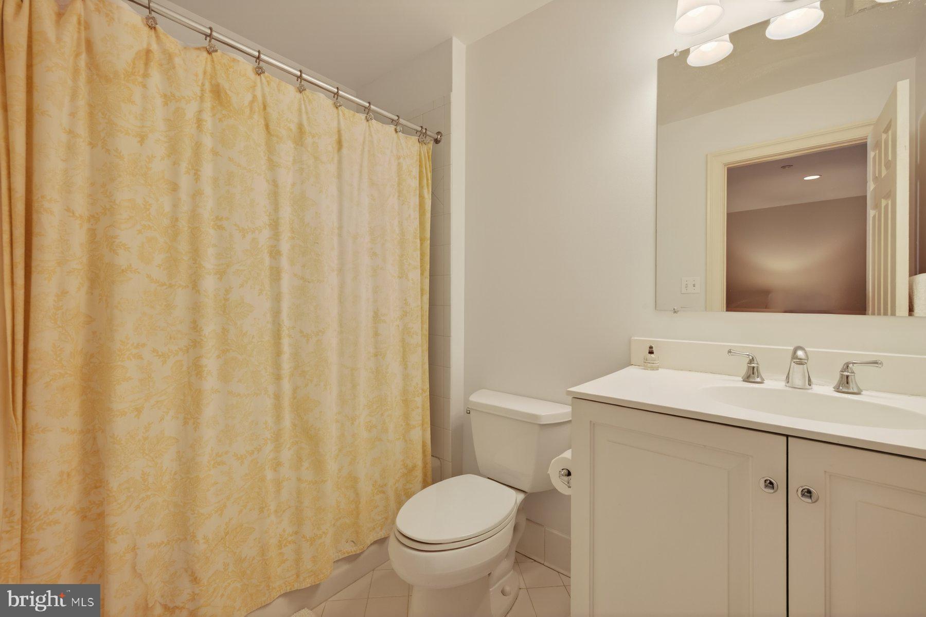 6115 Madawaska Road Bethesda, MD 20816 - Photo 53 of 78 a bathroom with a toilet a sink and a mirror